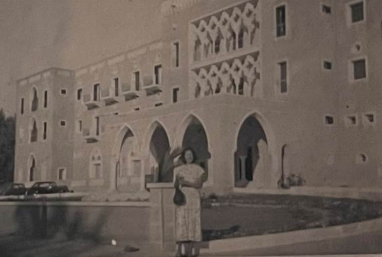 A person standing in front of a building
Description automatically generated with medium confidence